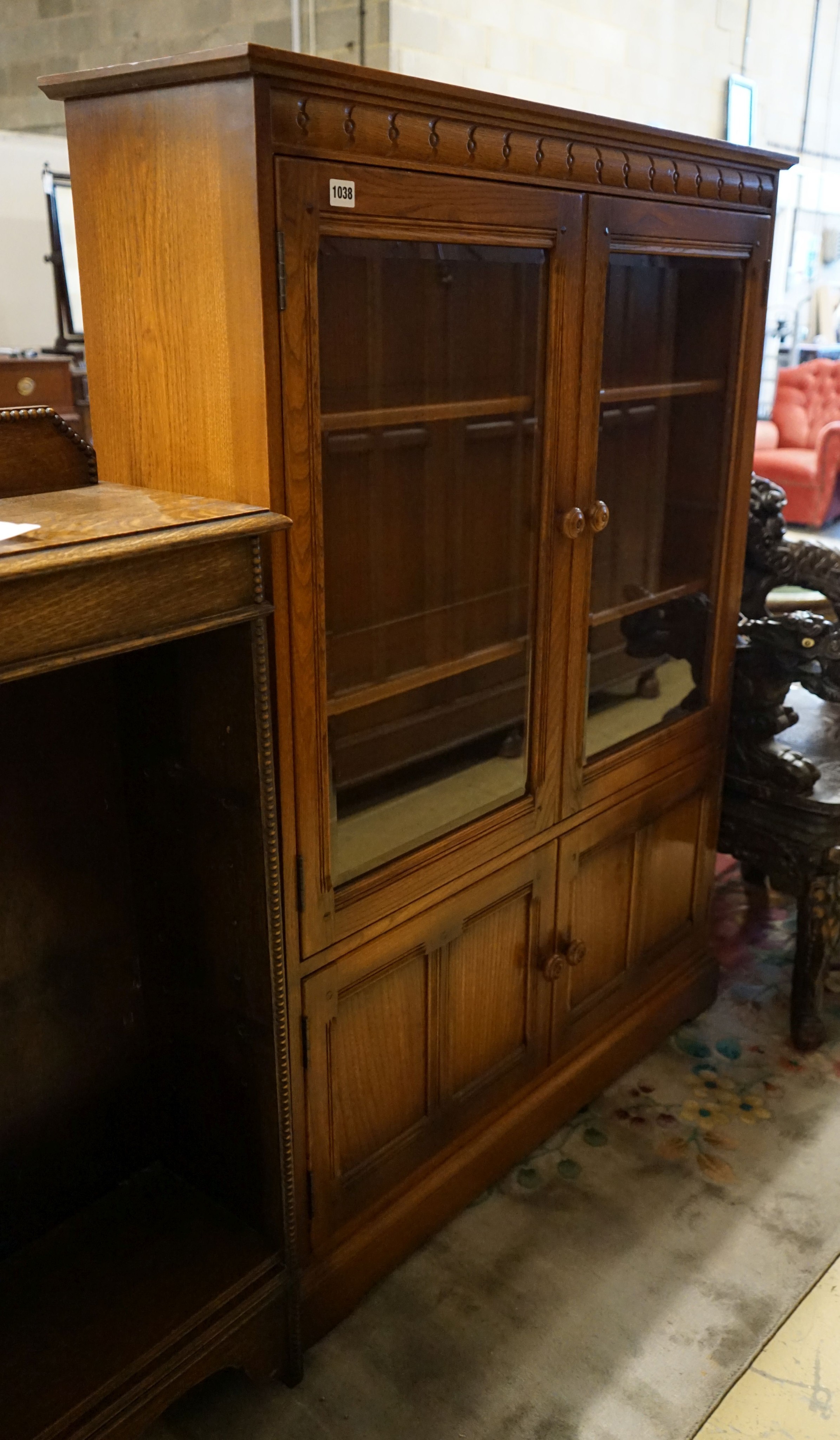 An Ercol elm bookcase, length 101cm, depth 30cm, height 137cm